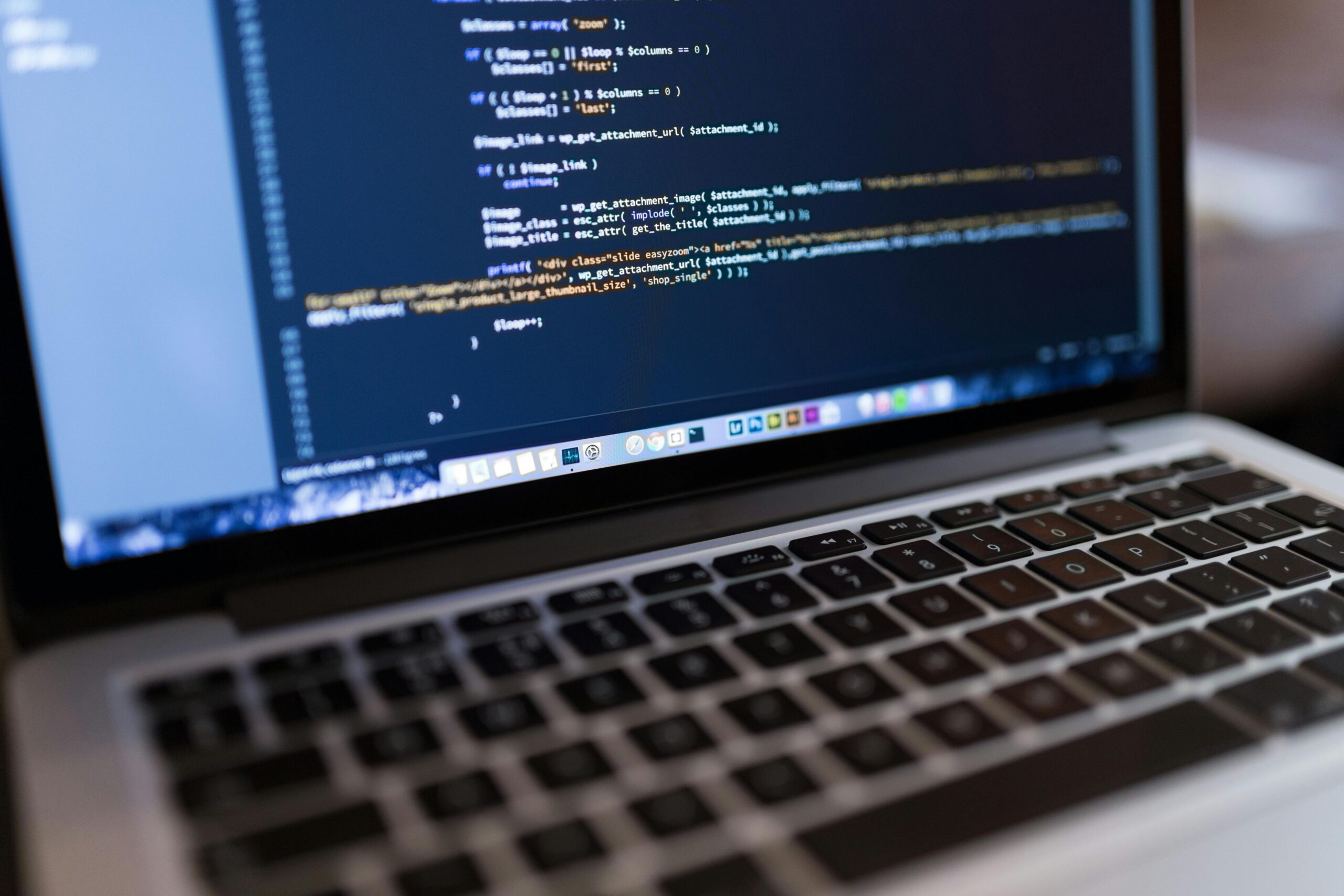 Close-up of a laptop screen displaying basic website development code.